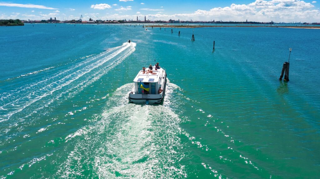 Aerial view of a houseboat cruising the Venetian Lagoon
