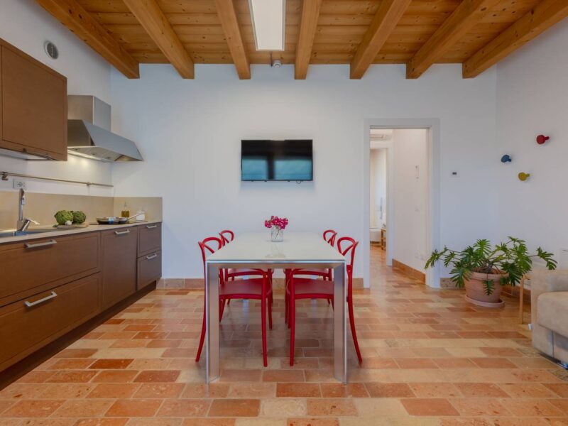 Kitchen-living room of a garden view apartment